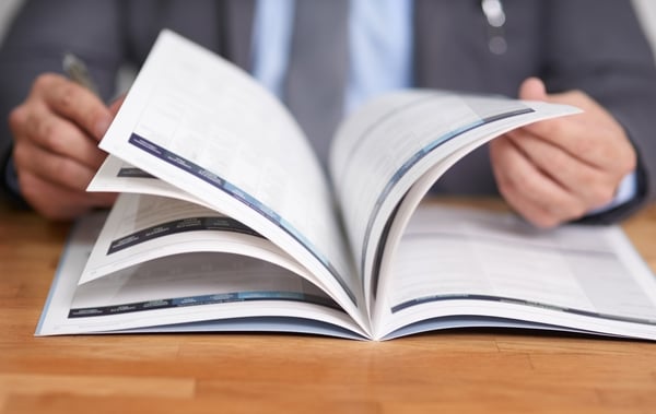 man in business suit looking at paperwork