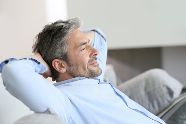Middle-aged business owner man having a restful moment relaxing bookkeeping