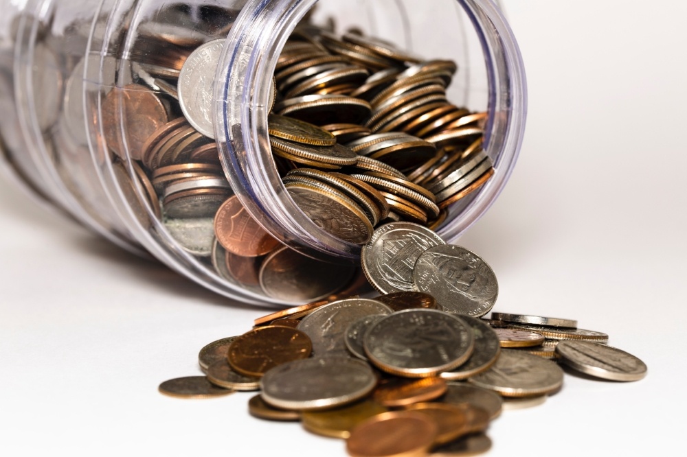 Jar of change spilling on table-036397-edited